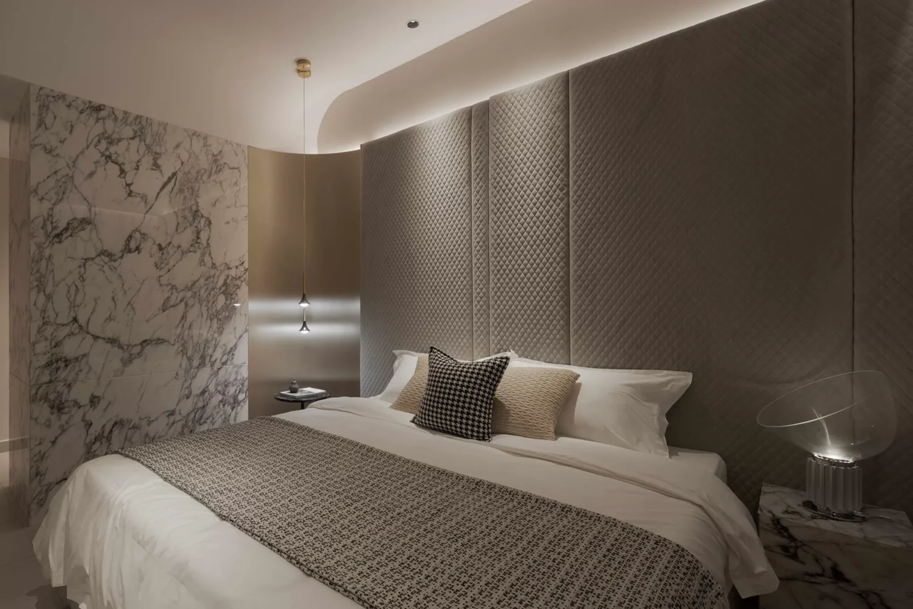 Actual showroom photograph of the Lumina Residences master bedroom with warm timber finishes